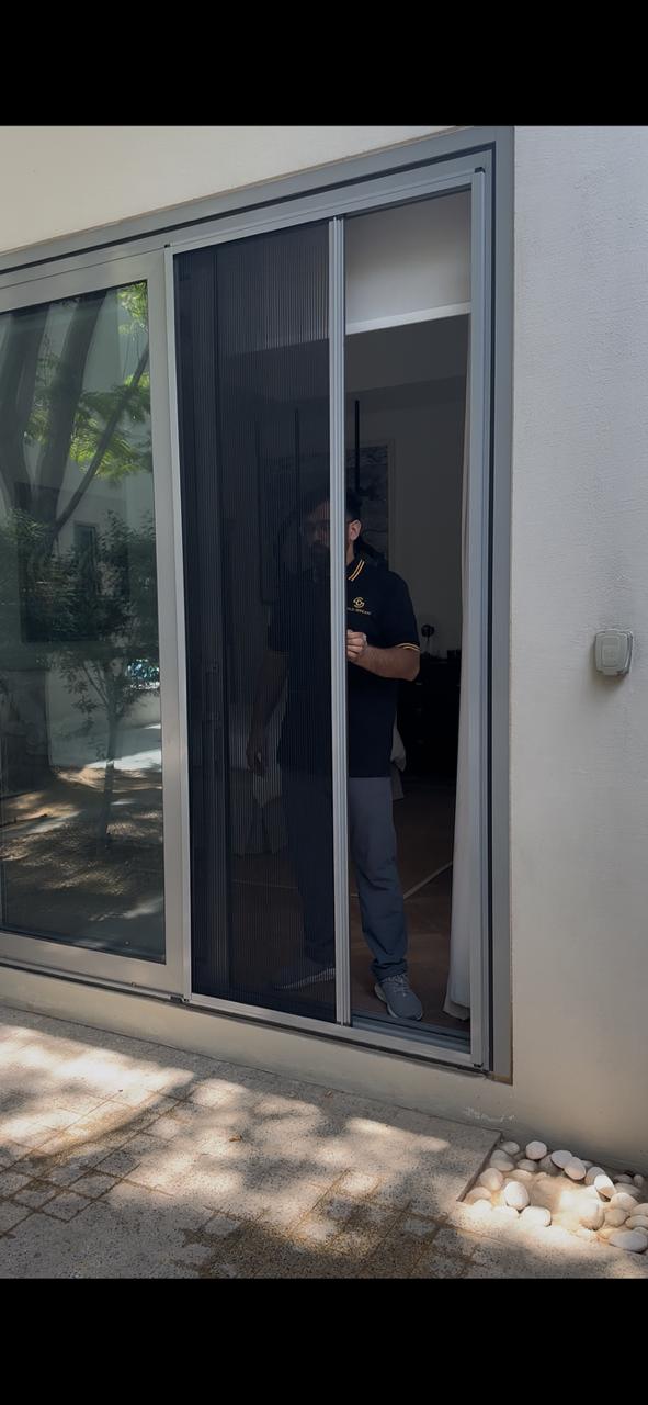 The Mosquito Net Pro team building insect screens at the workshop in Al Qusais, Dubai