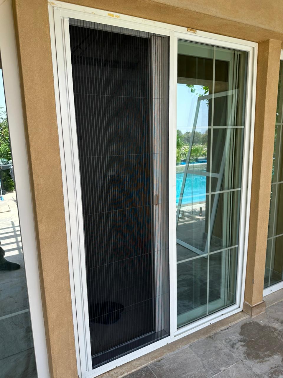 Sliding mosquito screen fitted to a balcony patio door of a Dubai home