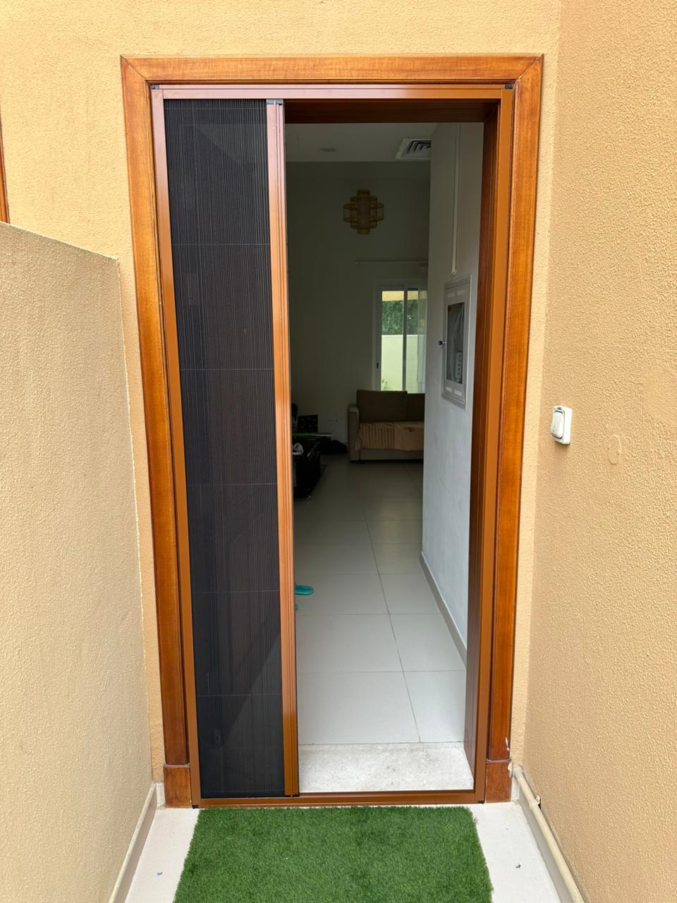 Magnetic mosquito screen fitted to a traditional wooden door in a Dubai home